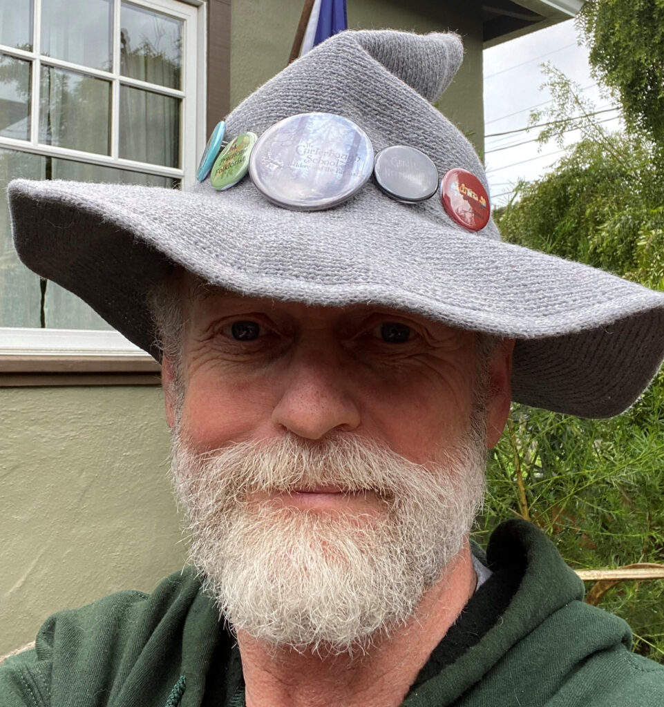 Steven Aelfcyning Aultman (he/him), in his Carterhaugh Hat of Many Buttons